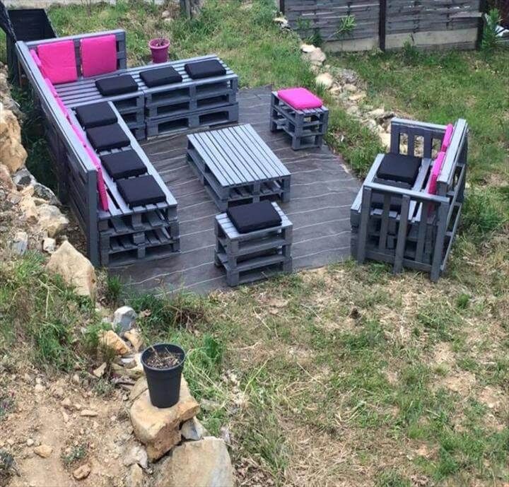 stacked pallet L-sofa with tables and benches