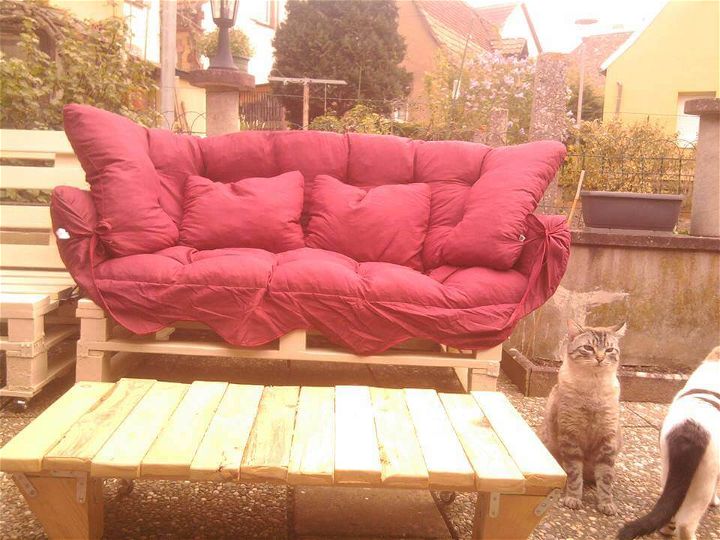 handmade wooden pallet sofa with red cushion