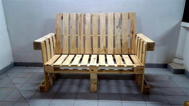 Wooden pallet bench with arms